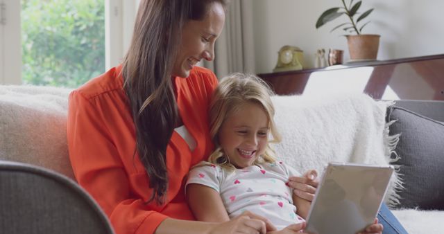 Mother and Daughter Enjoying Time with Digital Tablet on Couch - Download Free Stock Images Pikwizard.com