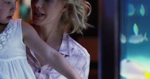 Mother and Daughter Admiring Aquarium Exhibit Together