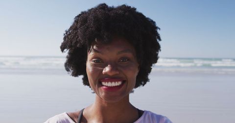Smiling Woman Enjoying Sunny Beach Day Near Ocean