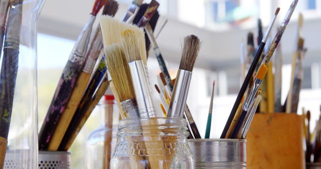 Collection of Artist Paintbrushes in Jars at Sunlit Studio - Download Free Stock Images Pikwizard.com