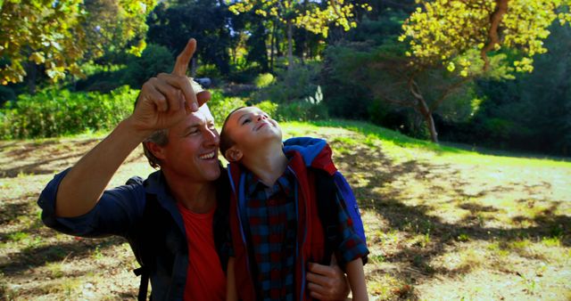 Father and Son Bonding in Sunny Park, Observing Nature Together - Download Free Stock Images Pikwizard.com