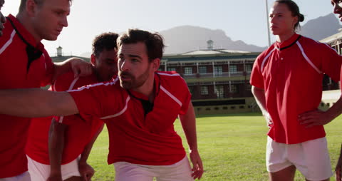 Rugby Team Strategizing on Field