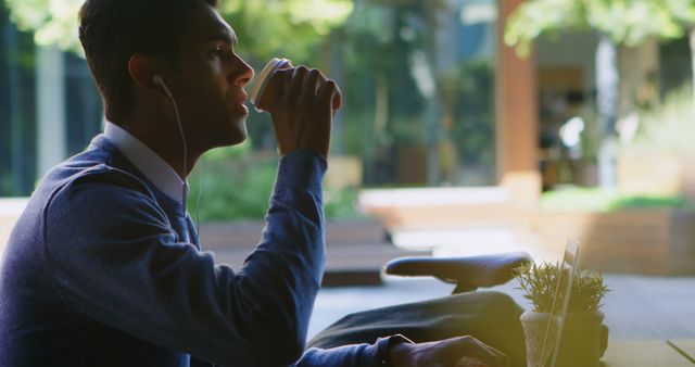 Businessman Enjoying Coffee Break With Earphones at Outdoor Workspace - Download Free Stock Images Pikwizard.com