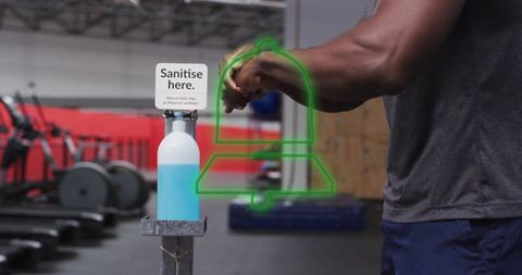Man using pedal hands sanitiser station in gym for hygiene