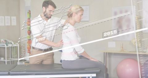 Physical therapist examining patient posture with spine alignment data overlay for rehab