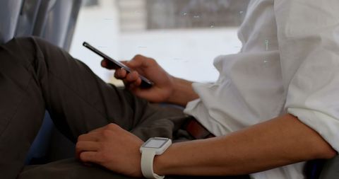 Close-Up Male Professional Using Smartphone with Smartwatch