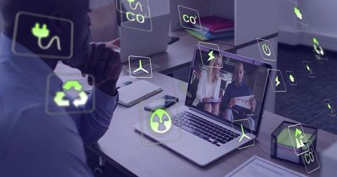 Businessman watching virtual sustainability presentation with floating energy icons and analytics