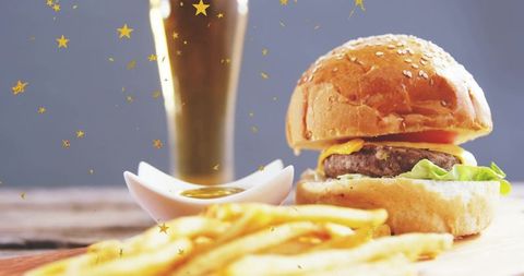Sesame burger with melting cheddar, crispy fries, dipping sauce and festive gold stars