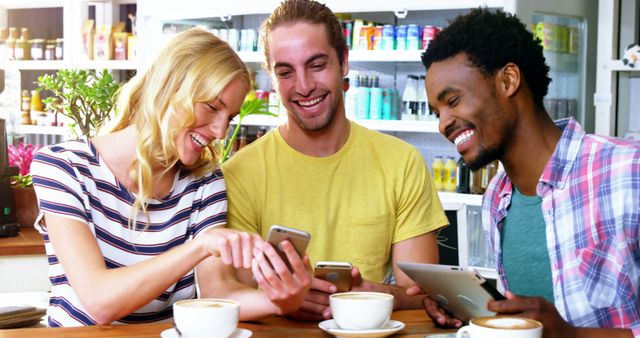 Diverse Friends Enjoying Coffee and Using Digital Devices in Café - Download Free Stock Images Pikwizard.com