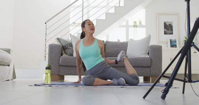 Woman Stretching in Living Room While Following Online Workout - Download Free Stock Images Pikwizard.com