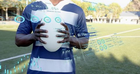 Rugby Player Holding Ball on Field with Augmented Reality Performance Analytics Overlay