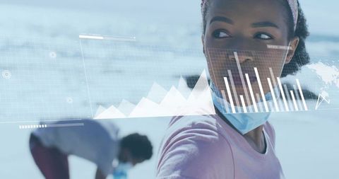 Young woman wearing mask on beach with augmented reality data charts and teamwork insights
