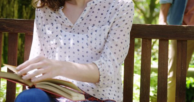 Woman in White Polka Dot Shirt Reading a Book Outdoors - Download Free Stock Images Pikwizard.com