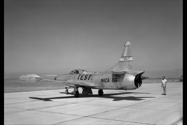 Historic image of Lockheed F-94C 156 with cooling air ejector displayed at NACA Ames Flight Line. Useful for aviation history enthusiasts, educational materials related to aeronautics, military aircraft research, or engineering technology presentations. Showcases advancements in aircraft design and testing processes. Ideal for articles, presentations, or documentaries related to aviation history and development of flight technology.