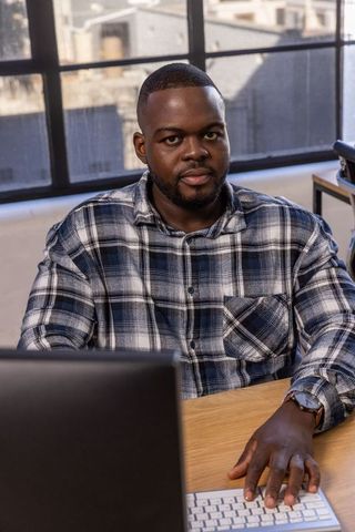 Young Professional Working on Keyboard in Modern Office