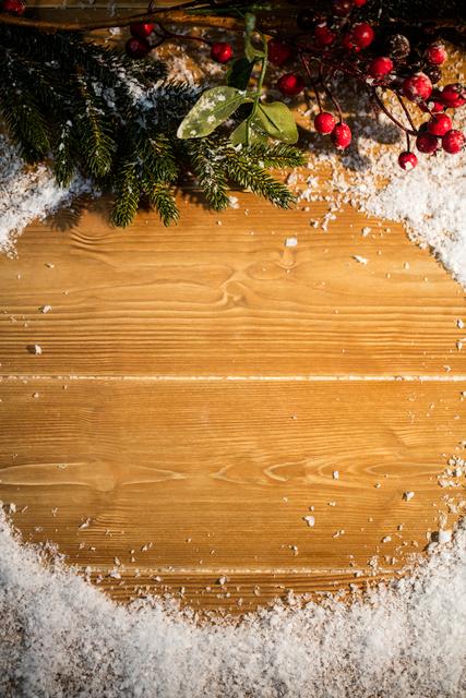 Close-up of festive Christmas decorations on a wooden plank, surrounded by snow. Perfect for use in holiday greeting cards, Christmas event invitations, seasonal blog posts, and festive advertising materials.