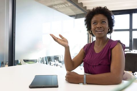 Businesswoman Presenting Digital Content at Office Desk