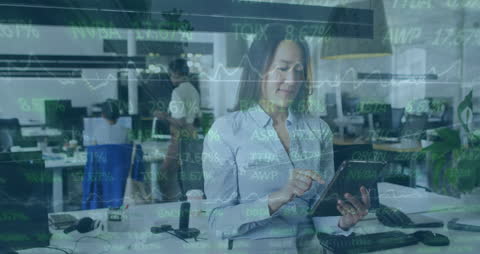Businesswoman Using Tablet for Financial Data in Office Environment