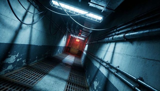 Angled industrial service corridor leading to red exit door with grated floor and pipes