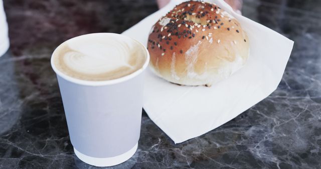 Cup of cappuccino and fresh bagel on marble table - Download Free Stock Images Pikwizard.com