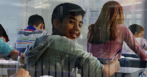 Teenage Boy Smiling in Classroom with Data Visualization
