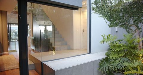 Modern home features minimalist glass staircase design