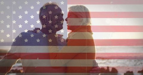 Happy Mature Couple Embracing at Scenic Beach During Sunset