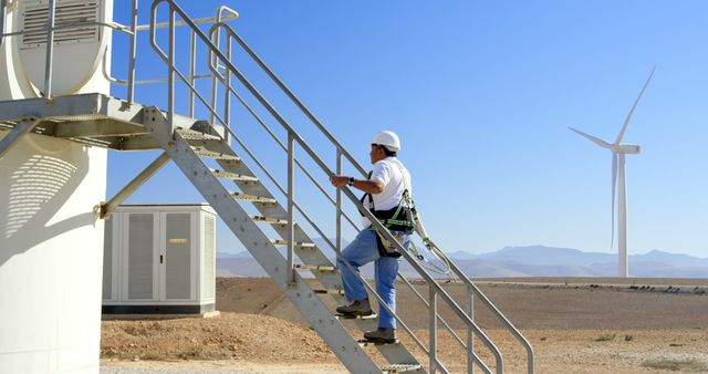 Engineer Climbing Ladder of Wind Turbine in Desert - Download Free Stock Images Pikwizard.com