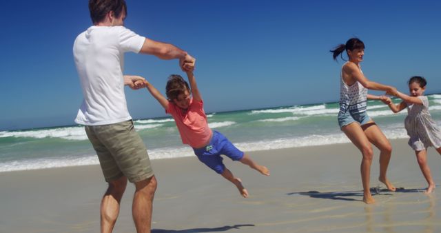 Happy Family Playing Together on Sandy Beach - Download Free Stock Images Pikwizard.com