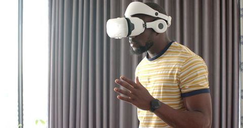 African American Man Immersed in VR Technology at Home
