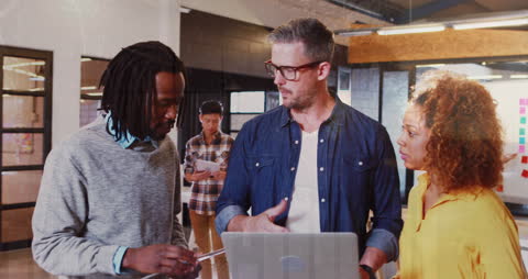 Diverse Group of Students Collaborating with Teacher in Modern School Setting