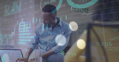 Analyst Examining Financial Data on Laptop in Office Setting