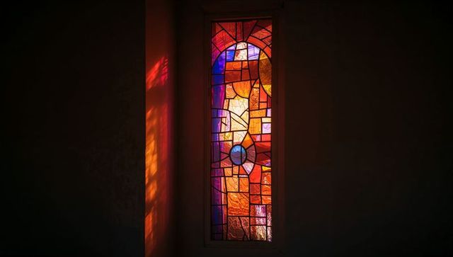 Colorful stained glass window illuminating chapel