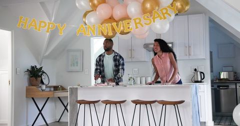 Happy Couple Cleaning Up After Home Anniversary Celebration