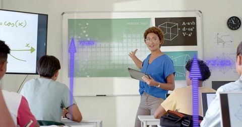 Instructor Teaching STEM Class Using Tablet and AR Periodic Table in Modern Classroom