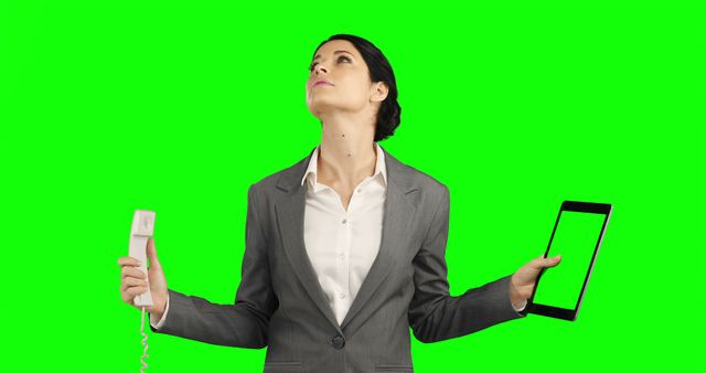 Stressed Businesswoman Balancing Work on Phone and Tablet with Green Background - Download Free Stock Images Pikwizard.com