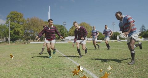 Rugby players chasing ball carrier on sunny grass pitch with gold star overlay
