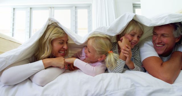 Happy Family Playing Under Blanket in Bedroom - Download Free Stock Images Pikwizard.com