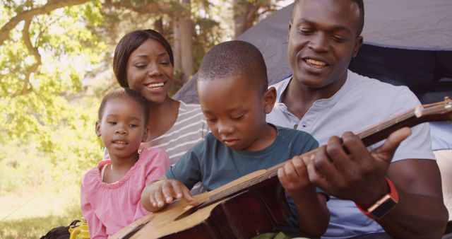 African American Family Enjoying Camping and Playing Guitar - Download Free Stock Images Pikwizard.com