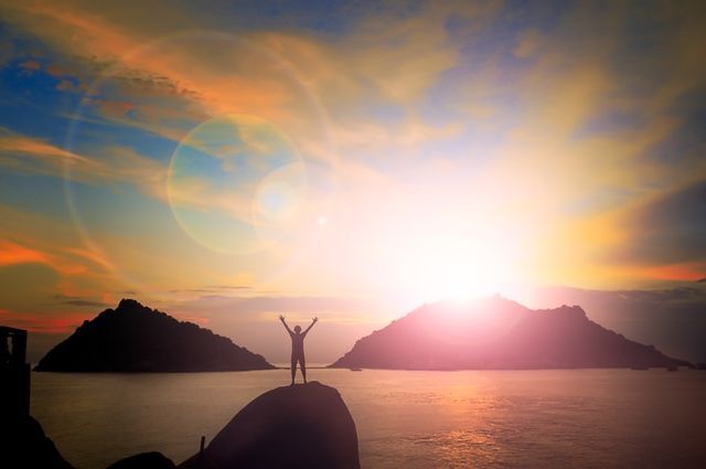 Silhouette of Triumphant Person at Sunrise on Mountain Top with Ocean View - Download Free Stock Photos Pikwizard.com