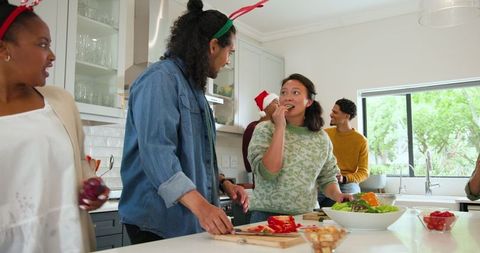 Friends Gather in Kitchen Preparing Feast with Joyful Atmosphere