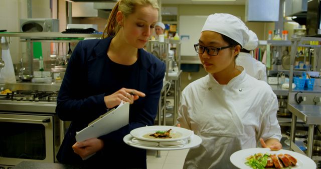 Chef Discussing Presentation with Culinary Student - Download Free Stock Images Pikwizard.com