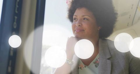 Businesswoman Gazing Out Airplane Window, Reflective Travel Portrait with Wristwatch Detail