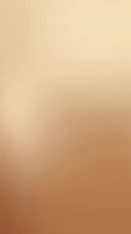 Vertical studio video showcasing soft beige gradient with autofocus lens shifting focus