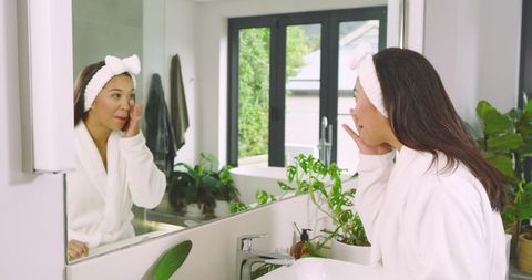 Woman practicing skincare routine in sophisticated bathroom interior