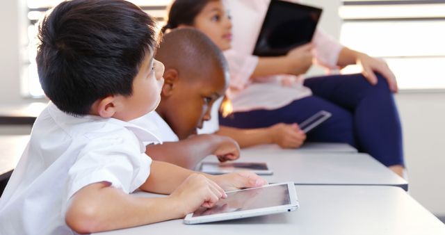 Young Students Learning with Tablets in Classroom - Download Free Stock Images Pikwizard.com