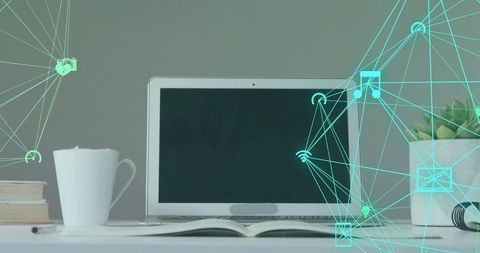 Laptop resting on clean white desk with open book, coffee mug and teal network overlay