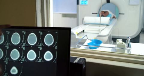 Ct control room showing brain scan monitor and patient entering gantry with sterile tray