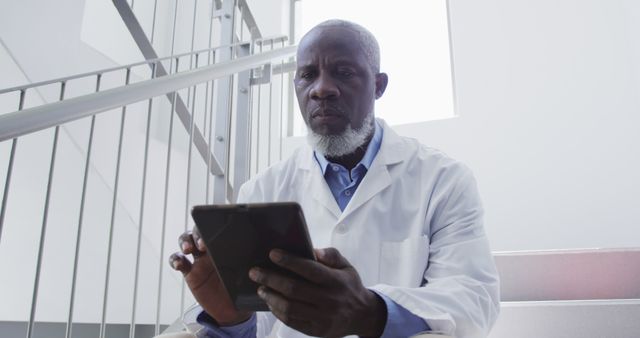 African American Doctor Using Digital Tablet on Hospital Staircase - Download Free Stock Images Pikwizard.com