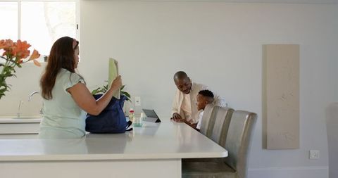 Family morning routine: preparing for school in kitchen setting